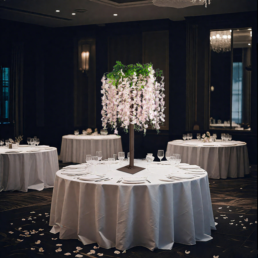 Elegant floral centerpiece on a banquet table in a sophisticated dining setting.