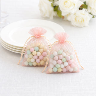 Pastel candy bonbonniere gift bags with drawstring on white table setting