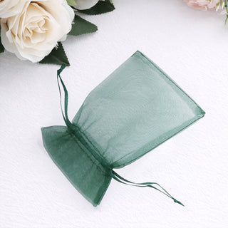 Green organza gift bag on a plain background