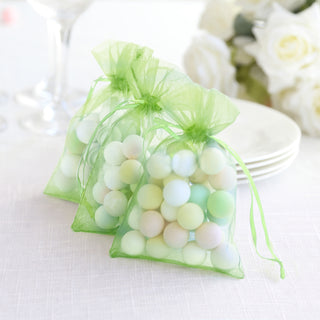 Pastel-colored decorative balls in sheer green bags for events or crafts.