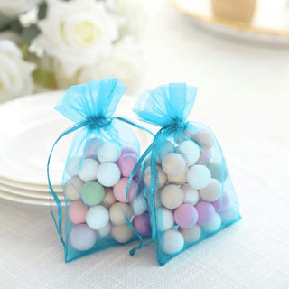 Colorful candy-filled organza bags tied with blue ribbons.