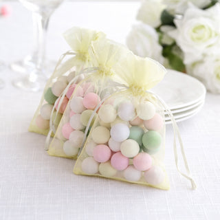 Colorful decorative candy bags on a table setting.