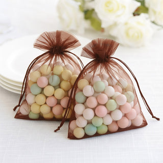 Colorful decorative candy bags in sheer brown pouches.