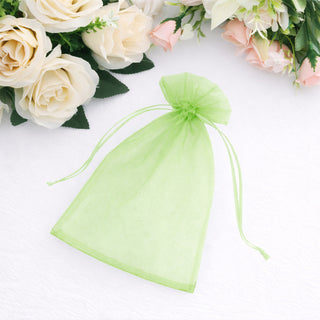 Green organza gift bag with drawstring closure on a white background.