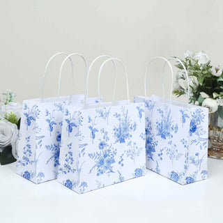 Floral-patterned gift bags with handles in a studio setting.