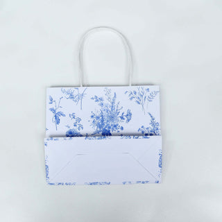 Floral print gift bag with a matching envelope on a plain background