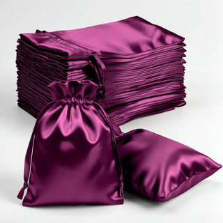 Purple satin drawstring bags and pillows on a white background.