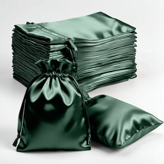 Green satin drawstring bags stacked and displayed on a white background.