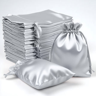 Silver satin drawstring bags in various sizes on a white background.