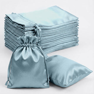 Stack of elegant blue satin bags with a drawstring closure