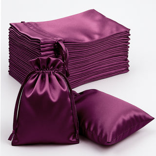 Purple satin drawstring bags stacked, showcasing elegant gift packaging.