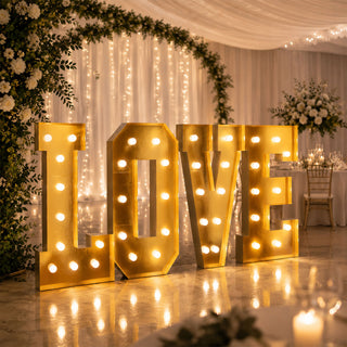 Illuminated gold LOVE sign at elegant wedding reception venue