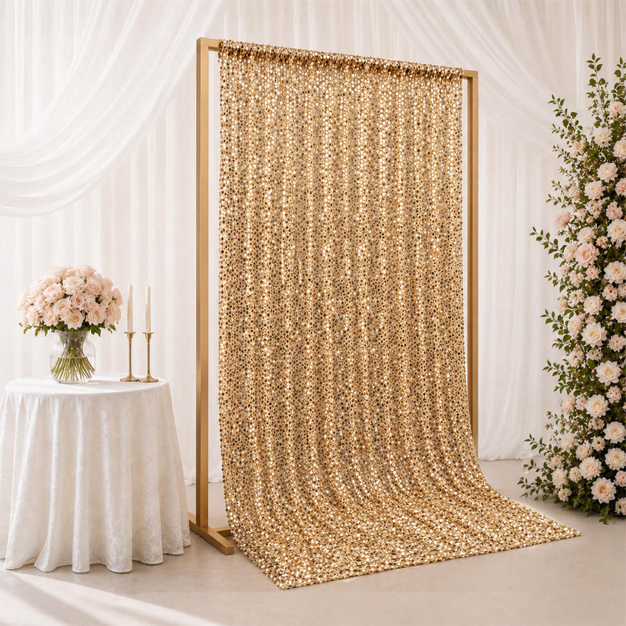 Gold sequin wedding backdrop with floral decor and draped white curtains