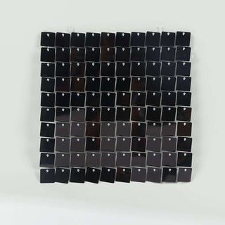 Black square tile mosaic wall art on a white background.