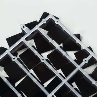 Black plastic triangle cutouts in a clear organizer tray