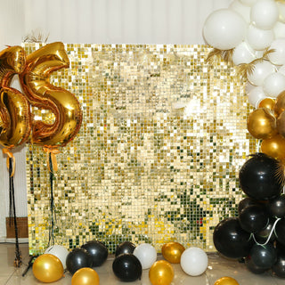 Celebratory backdrop with gold and black balloons and a sparkling golden wall.