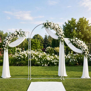 Elegant outdoor wedding arch with white floral garlands and draped fabric