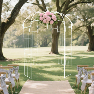 Wedding arch with floral arrangement in outdoor setting.