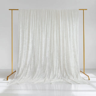White velvet backdrop draped on a gold stand for photography