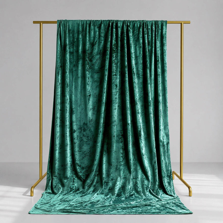 Emerald green velvet draped backdrop on gold frame studio stand