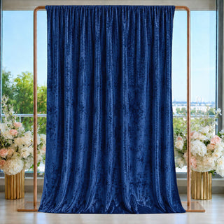 Navy blue velvet curtain backdrop with gold frame and floral arrangements