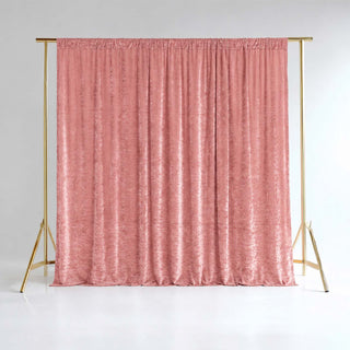 Pink velvet curtain on gold backdrop stand in a studio setting