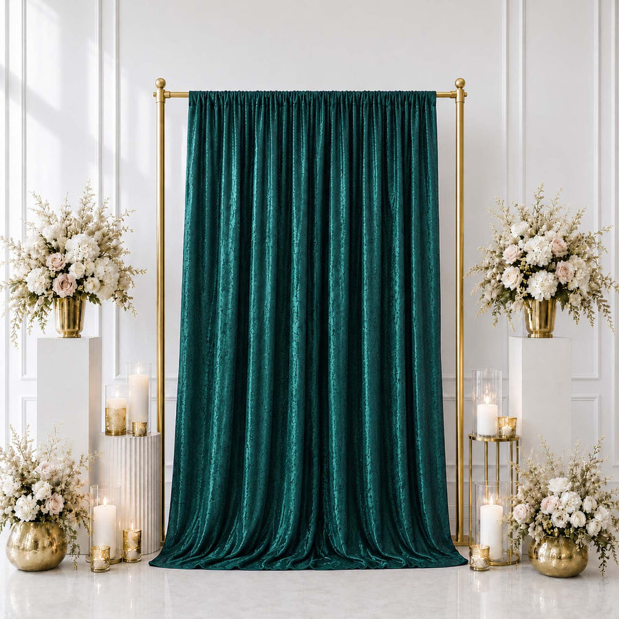 Elegant emerald green curtain backdrop with gold stand and floral wedding decor