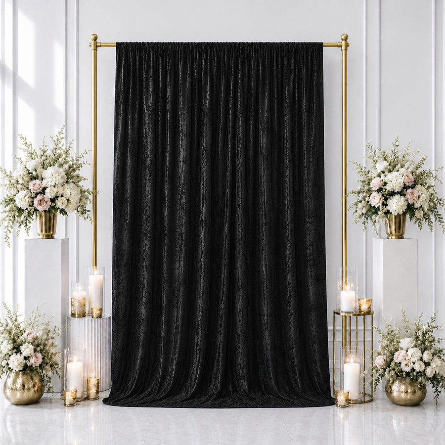 Elegant black wedding backdrop with gold frame and floral arrangements