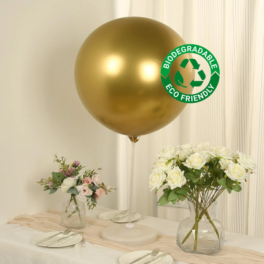 Gold biodegradable balloon with eco-friendly label on table with flowers.