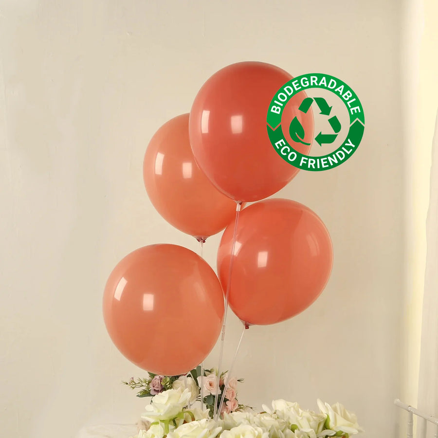 Biodegradable eco-friendly balloons in coral orange color.