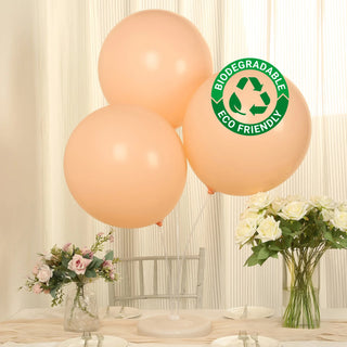 Peach biodegradable balloons with eco-friendly label on a table setting
