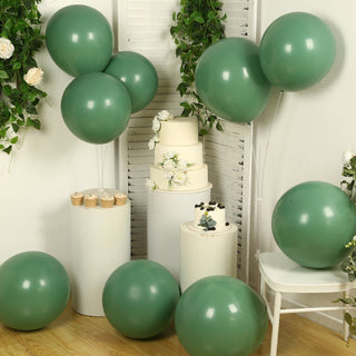 Green balloons with cakes and cupcakes in a decorated setting.
