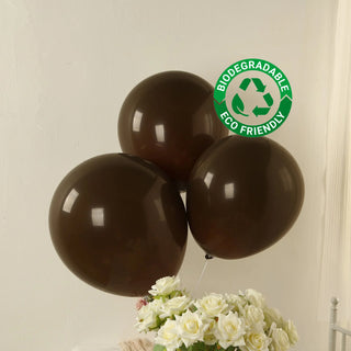 Brown biodegradable balloons with eco-friendly label, arranged with white flowers.