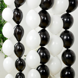 Black and white balloons arranged in a decorative garland.
