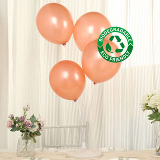 Biodegradable rose gold balloons on a table with flowers