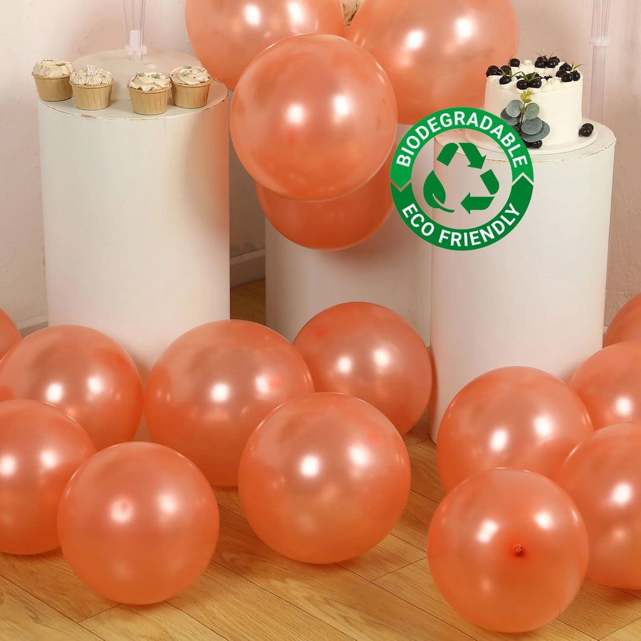 Biodegradable peach balloons scattered around a party setup.