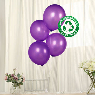 Purple biodegradable balloons with eco-friendly label against a light background.