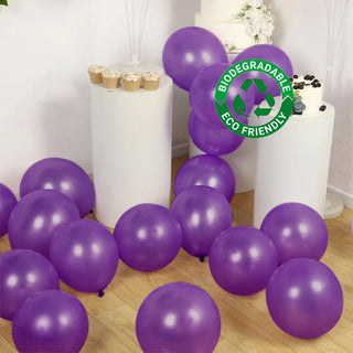 Purple biodegradable balloons scattered on a wooden floor. Eco-friendly celebration decor.