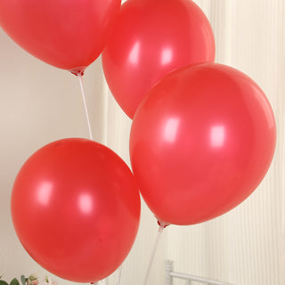 Red helium balloons in a playful arrangement.
