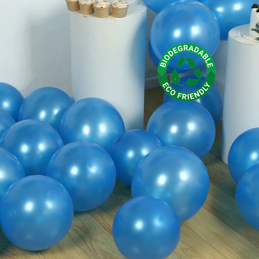 Blue biodegradable balloons scattered on a wooden floor. Eco-friendly design.