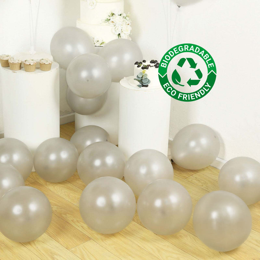 Biodegradable eco-friendly balloons scattered on a wooden floor.