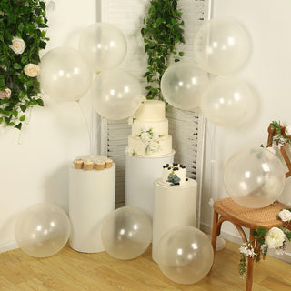 Decorative balloons and cakes at a festive event with floral accents.
