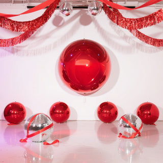 Red balloons and disco balls in a festive setting.