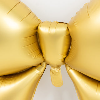 Gold balloon bow decoration for parties and celebrations