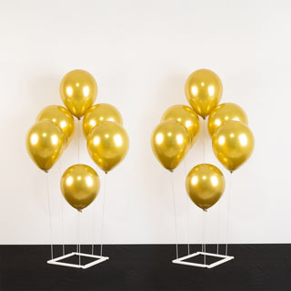 Gold helium balloons on white background