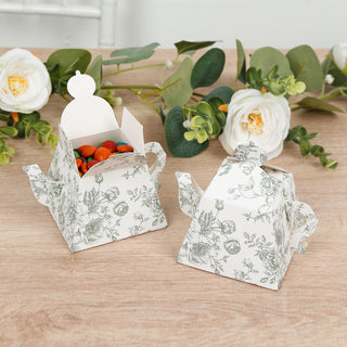 Decorative floral tea party favor boxes with colorful candies inside.