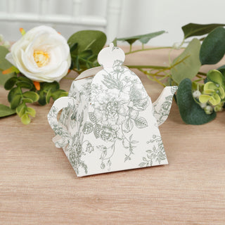 Floral-patterned teapot with a unique shape on a wooden surface.