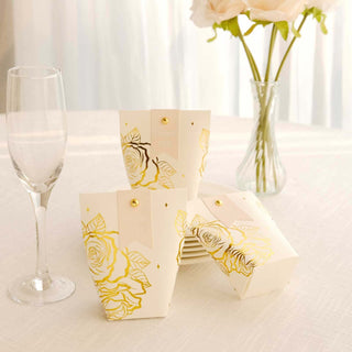 Elegant floral gift boxes on a table with a glass and vase.