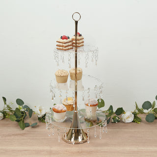Elegant three-tier cupcake stand with crystal accents and decorative desserts.
