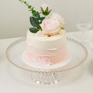 Elegant three-tiered cake adorned with roses and delicate pearls.